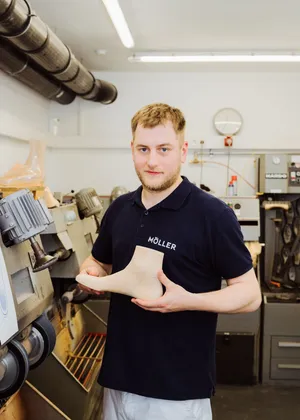 Ein Mitarbeiter hält eine Leiste